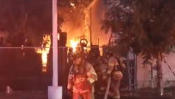 At least 45 Fresno, CA, firefighters--half of the deparment&apos;s on-duty resources--battled a three-alarm blaze that started as an apparent grass fire and threatened a tire shop and a homeless encampment.