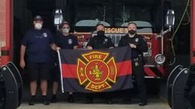 Hanover Township, PA, firefighters show off a recovered memorial flag that was stolen last week from the department.