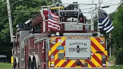 A Hingham, MA, fire apparatus displays a 'thin blue line' flag supporting police officers.