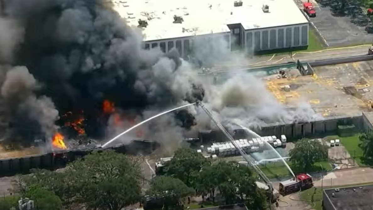 Houston firefighters battled a three-alarm blaze that erupted Friday at a warehouse that houses a cosmetics suppliers.