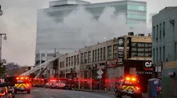 Firefighters work to put out a large commercial fire in downtown Los Angeles that injured 12 firefighters and left multiple buildings ablaze May 16.