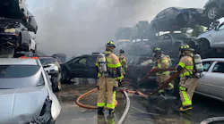 Dozens of Miami-Dade firefighters battled a junkyard blaze that charred at least 20 cars Friday.