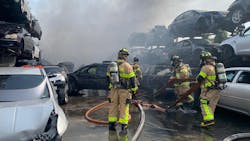 Dozens of Miami-Dade firefighters battled a junkyard blaze that charred at least 20 cars Friday. Dozens of Miami-Dade firefighters battled a junkyard blaze that charred at least 20 cars Friday.