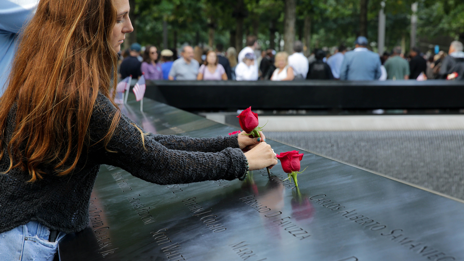 A mourner places a rose for a loved one during the 2019 anniversary ceremony in New York City for the Sept. 11 attacks.
