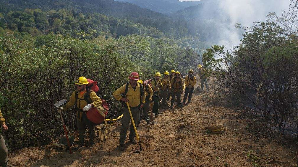 Oregon Department of Forestry firefighters finish mopping up the Shangrila Lane Fire near Rogue River on Tuesday.