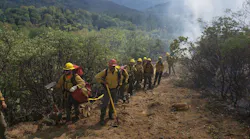 Oregon Department of Forestry firefighters finish mopping up the Shangrila Lane Fire near Rogue River on Tuesday.