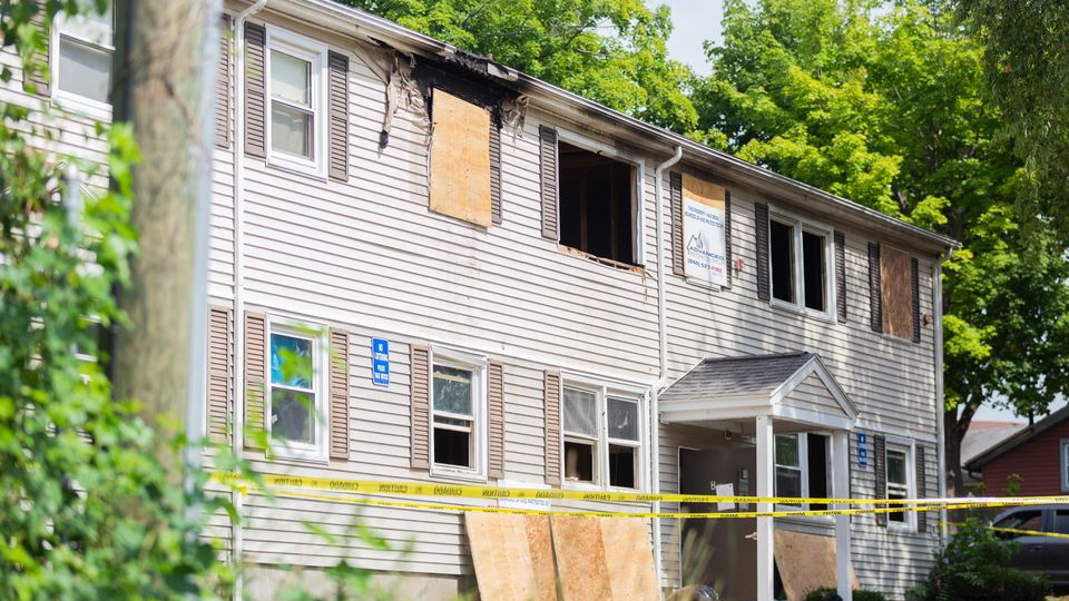A man, 35, was arrested and charged after allegedly setting his bed on fire inside a public housing unite Tuesday, and a Springfield, MA, firefighter suffered minor injuries in the ensuing blaze.