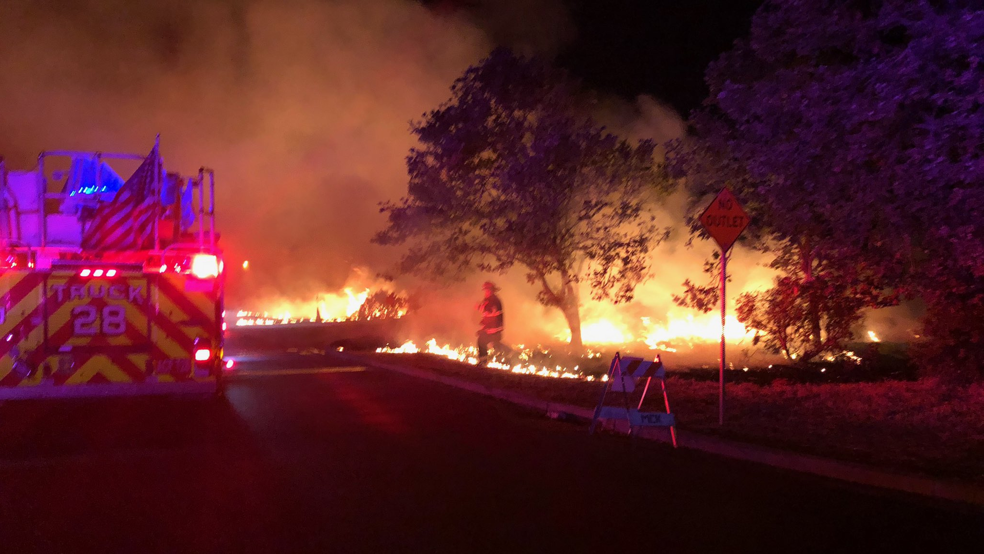 Alameda County firefighters work to control a vegetation fire in Newark, CA.