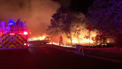 Alameda County firefighters work to control a vegetation fire in Newark, CA.
