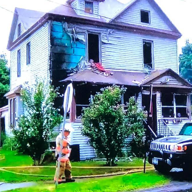 Syracuse, NY, firefighters rescued an unconscious woman found on the second floor of a burning house Wednesday.