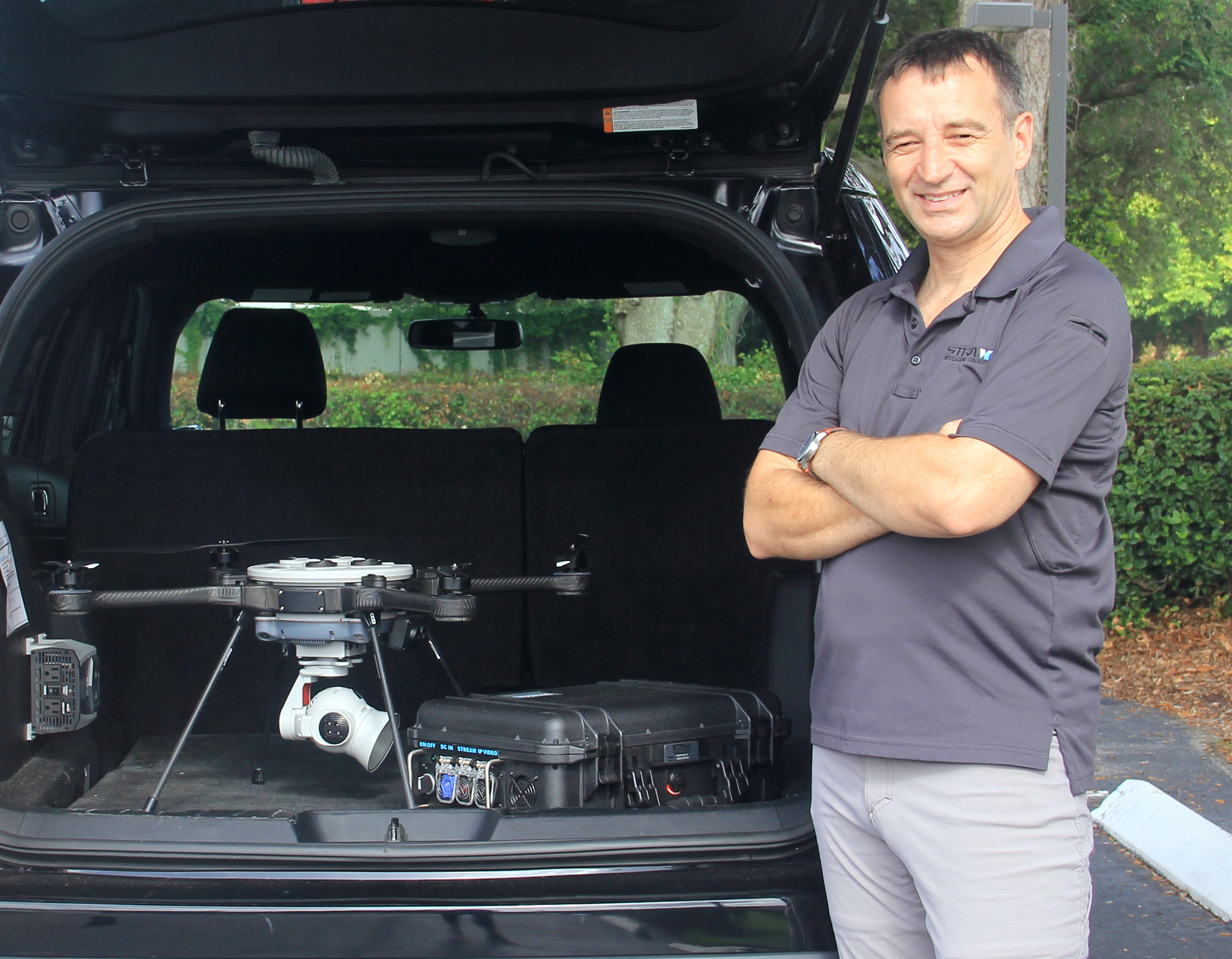 Dean Attridge, vice president of STRAX Intelligence Group's Field Operations with the PoDD and a drone.