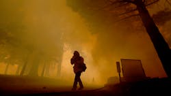 Firefighters are enveloped in smoke from the Apple Fire as they battle the blaze at the Oak Canyon Conservation Camp near Beaumont, CA, on Saturday. Firefighters are enveloped in smoke from the Apple Fire as they battle the blaze at the Oak Canyon Conservation Camp near Beaumont, CA, on Saturday.