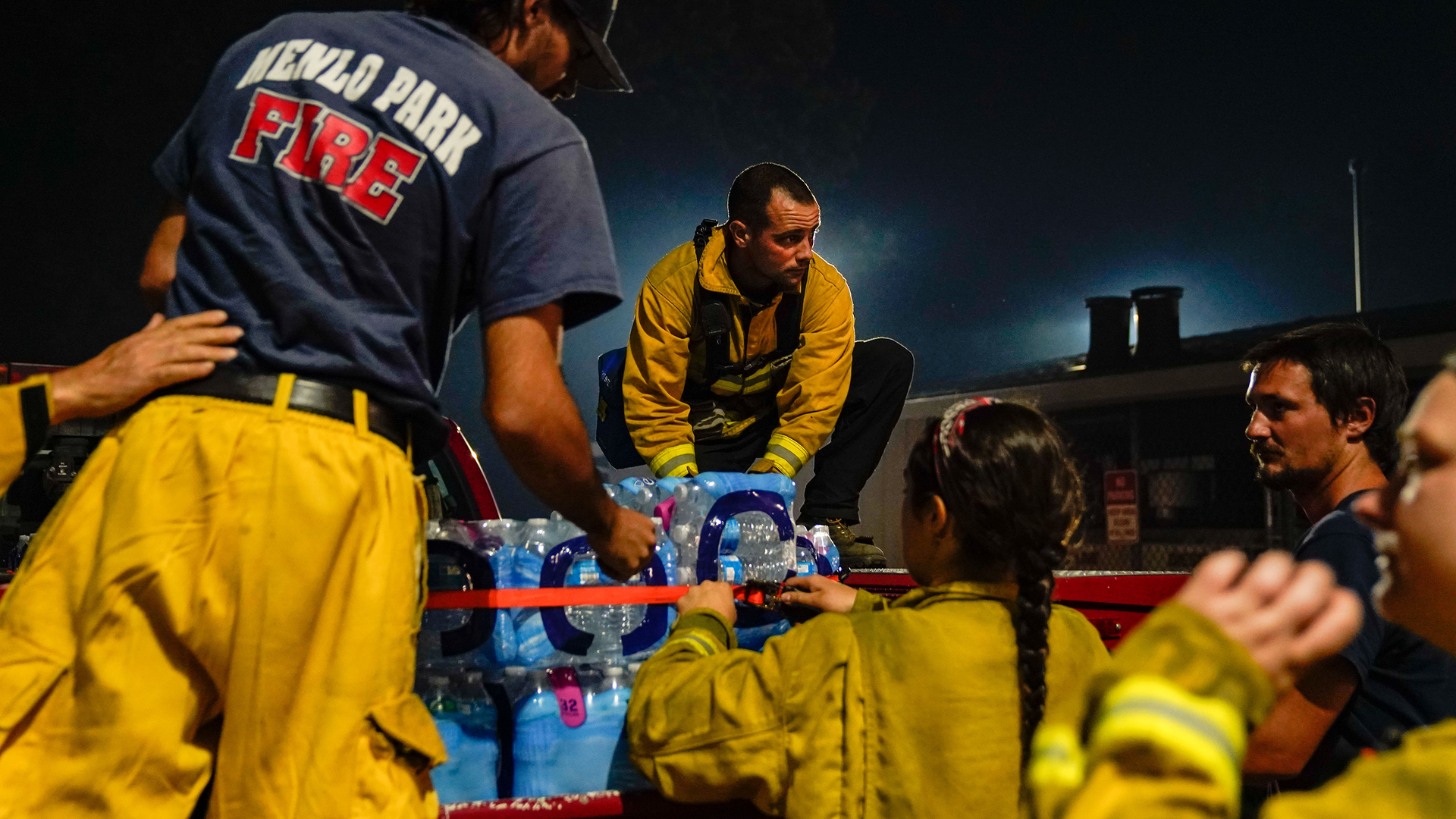 Supplies are unloaded from a Menlo Park, CA, vehicle at the Boulder Creek Volunteer Fire Department station Friday during the CZU Lightning Complex fires.