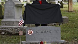 Columbus, OH, firefighter Stephen Cox unveils the new headstone for Columbus firefighter Mark Newman during a ceremony at Green Lawn Cemetery on Tuesday. Columbus, OH, firefighter Stephen Cox unveils the new headstone for Columbus firefighter Mark Newman during a ceremony at Green Lawn Cemetery on Tuesday.