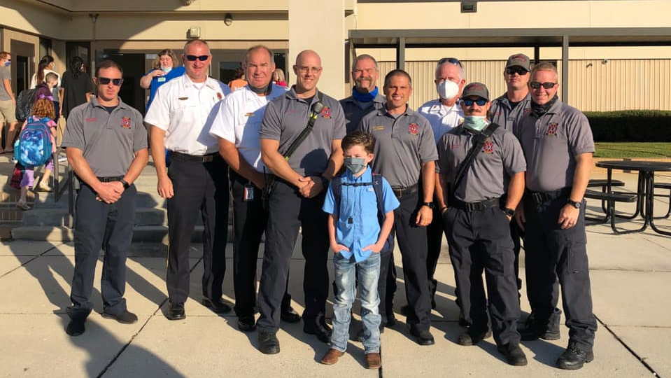 Easton Dodd, son of firefighter Kyle Dodd, who died unexpectedly last month, was escorted to school Tuesday by firefighters from Oneonta, AL, Fire and Rescue Service and Center Point Fire District.