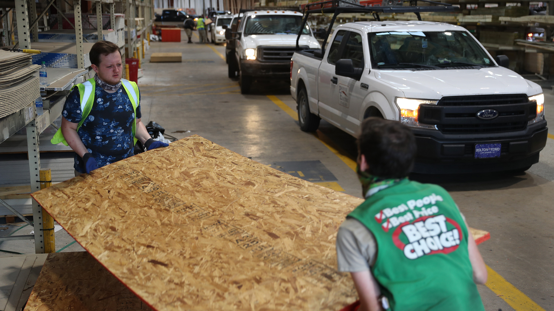 David Rosenbaum Jr. (left) and Devlin Cudd load plywood into vehicles as people purchase supplies at the Stine hardware store before the possible arrival of Hurricane Laura on Wednesday in Lake Charles, LA.