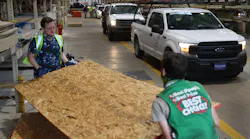 David Rosenbaum Jr. (left) and Devlin Cudd load plywood into vehicles as people purchase supplies at the Stine hardware store before the possible arrival of Hurricane Laura on Wednesday in Lake Charles, LA.