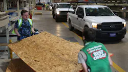 David Rosenbaum Jr. (left) and Devlin Cudd load plywood into vehicles as people purchase supplies at the Stine hardware store before the possible arrival of Hurricane Laura on Wednesday in Lake Charles, LA.