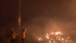 Firefighters save a U.S. flag Wednesday caught in the Lake Fire that has burned more than 10,000 acres in the Lake Hughes, CA. Firefighters save a U.S. flag Wednesday caught in the Lake Fire that has burned more than 10,000 acres in the Lake Hughes, CA.