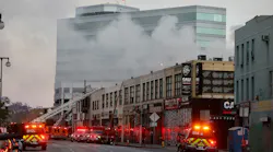 Firefighters at the scene of a commercial fire in downtown Los Angeles that has injured 11 firefighters and left multiple buildings ablaze May 16. The owners connected to the massive downtown explosion face 300 criminal charges.