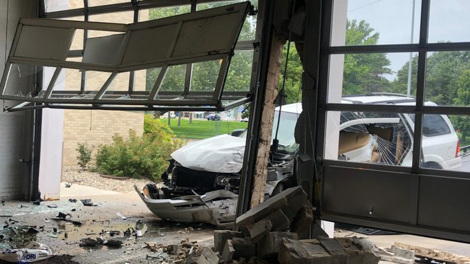 A 92-year-old driver was injured following a two-vehicle crash that damaged a Manhattan, KS, fire station Tuesday.