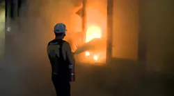 Minneapolis crews rescued two people and battled fires at four businesses amid riots and looting late Wednesday.