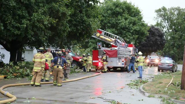Nevada, IA, firefighters deal with the extensive damage caused by a major storm that tore through the city Monday.