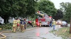 Nevada, IA, firefighters deal with the extensive damage caused by a major storm that tore through the city Monday.