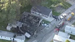 A woman was found dead and another person was rescued after a mobile home caught fire and spread to two nearby trailers in New Chicago, IN, on Thursday.