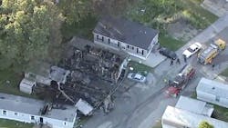 A woman was found dead and another person was rescued after a mobile home caught fire and spread to two nearby trailers in New Chicago, IN, on Thursday. A woman was found dead and another person was rescued after a mobile home caught fire and spread to two nearby trailers in New Chicago, IN, on Thursday.