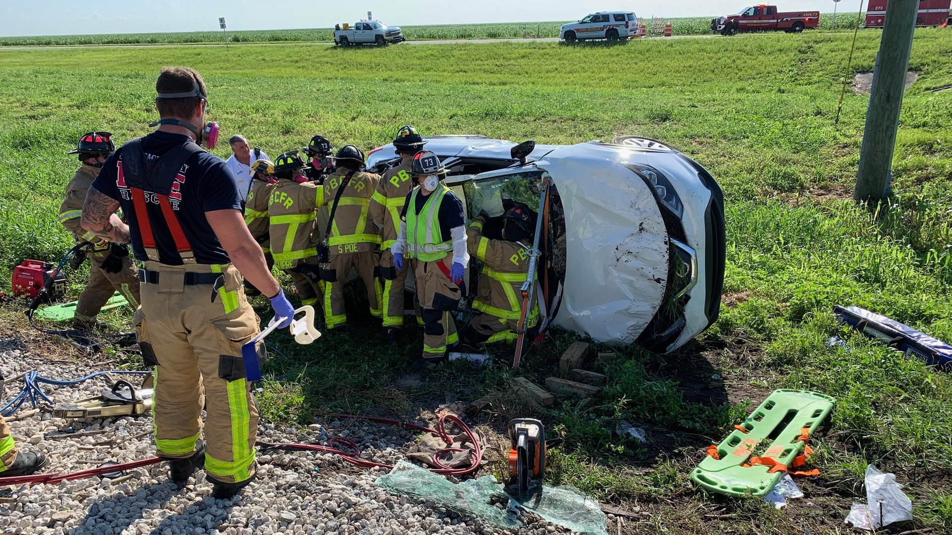 Palm Beach County, FL, firefighters extricated two adults and an infant trapped inside a car that rolled over after it was struck by a train in Belle Glade early Friday.