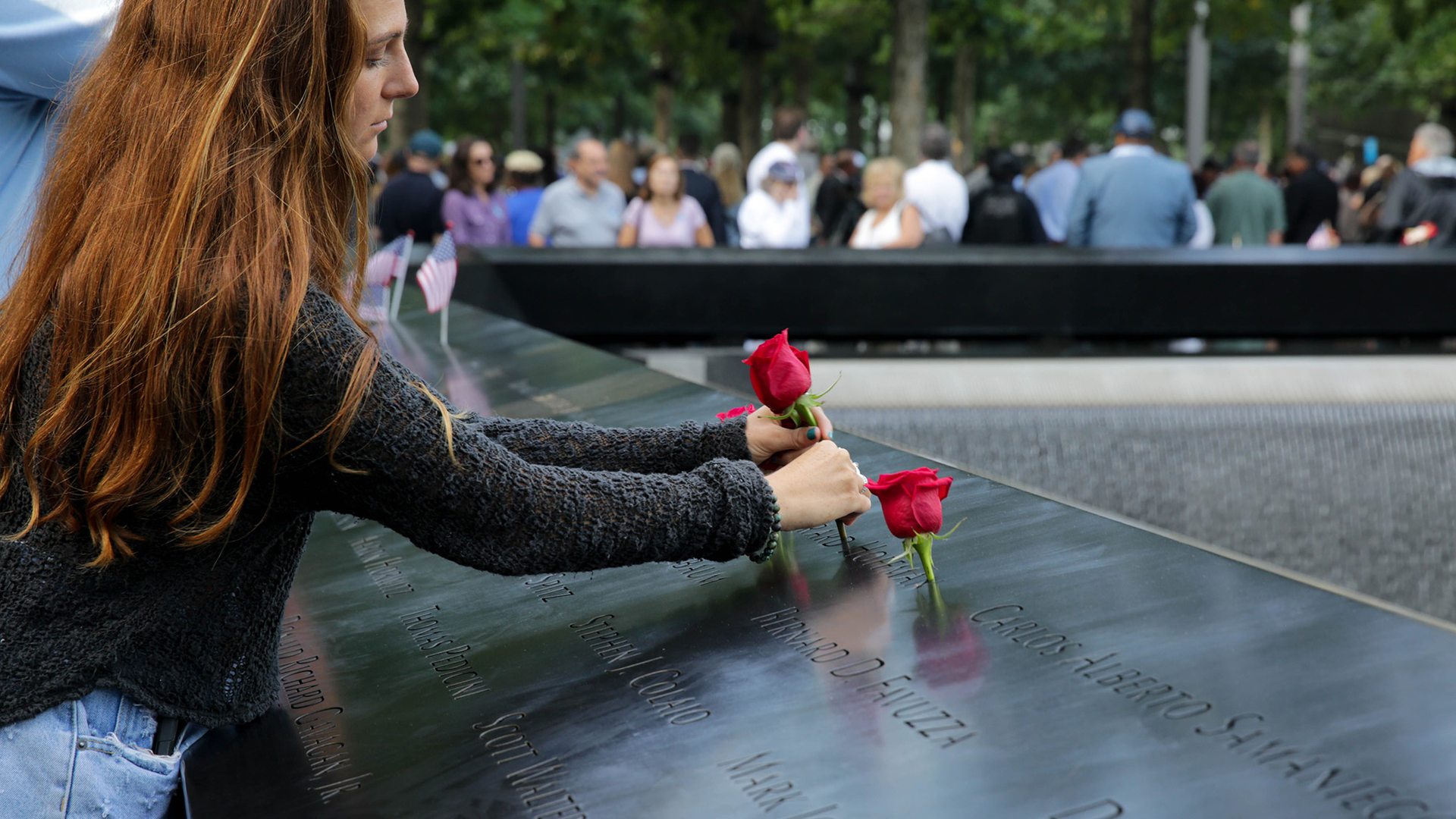 A mourner places a rose for a loved one during the 2019 anniversary ceremony in New York City for the Sept. 11 attacks.