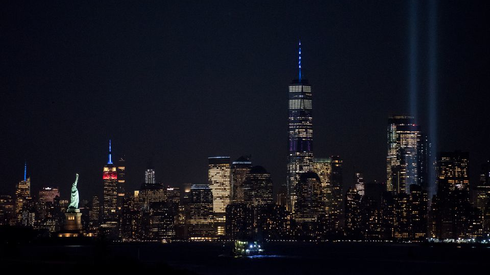 The'Tribute in Light' shines from Manhattan, with the One World Trade Center, the Empire State Building lit up in red, white and blue, and the Statue of Liberty, as seen across the Hudson River from Bayonne, NJ, on the 18th anniversary of the 9/11 attacks.