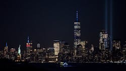 The&apos;Tribute in Light&apos; shines from Manhattan, with the One World Trade Center, the Empire State Building lit up in red, white and blue, and the Statue of Liberty, as seen across the Hudson River from Bayonne, NJ, on the 18th anniversary of the 9/11 attacks.