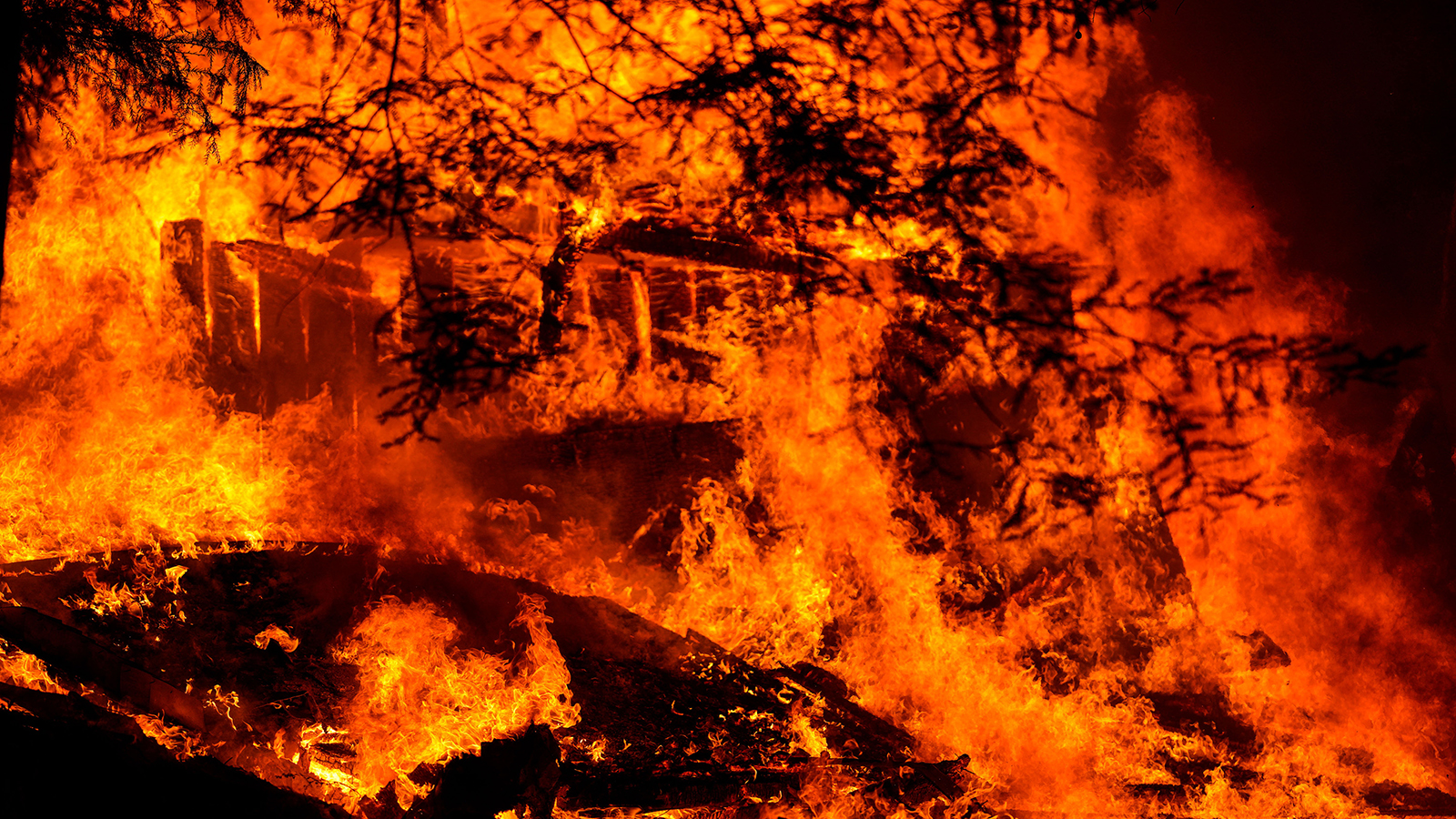 A structure burns along Riverdale Boulevard in Boulder Creek, CA, during the CZU Lightning Complex Fire on Aug. 23, 2020.