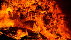 A structure burns along Riverdale Boulevard in Boulder Creek, CA, during the CZU Lightning Complex Fire on Aug. 23, 2020.