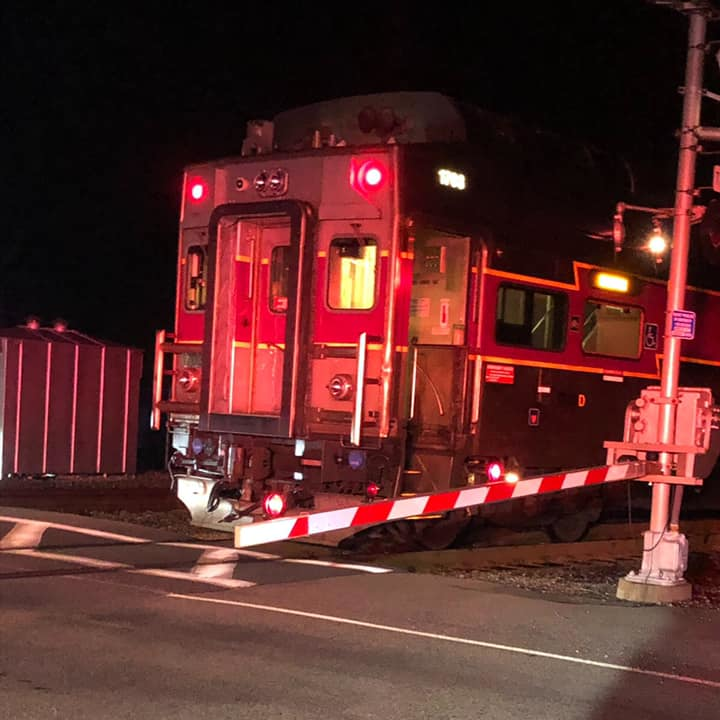 Abington, MA, firefighters helped a woman after she escaped her disabled car before it was struck by a train early Sunday.