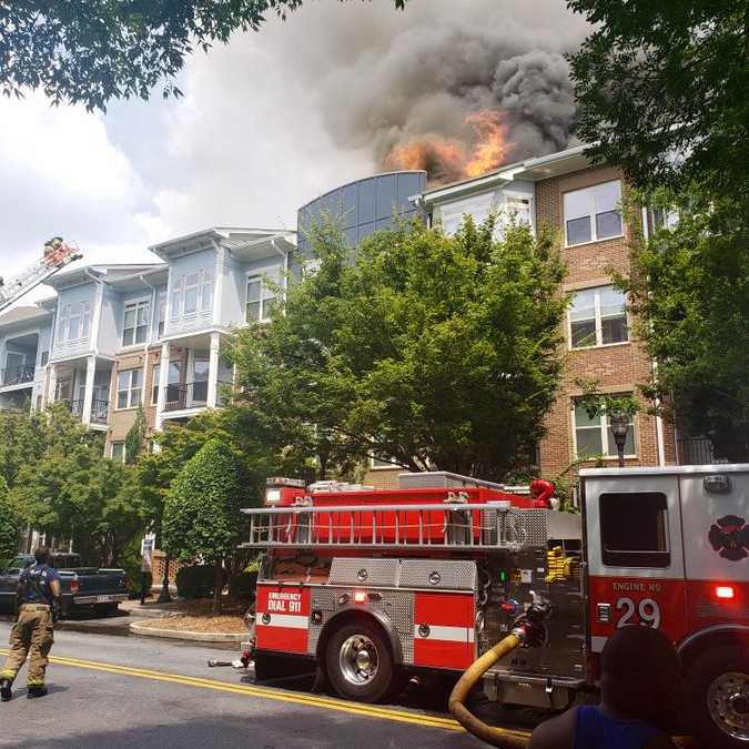 An Atlanta fire captain was taken to the hospital with a serious knee injury after a wall collapse during a two-alarm apartment blaze Wednesday.