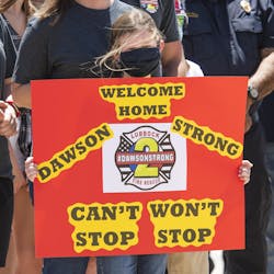 Hayden Brown holds a sign to welcome Lubbock, TX, firefighter Matt Dawson back to Lubbock at Lubbock Fire Administration on Thursday. Hayden&apos;s father, Dustin Brown, was one of the firefighters that accompanied Dawson to Colorado for rehabilitation.