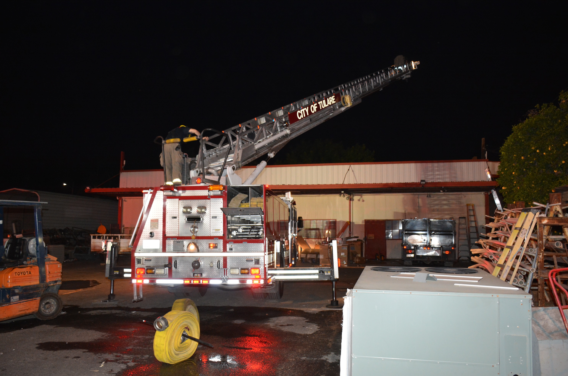 Tulare Fire Department&rsquo;s Truck 61 arrived on scene last among the four apparatus that responded to a reported commercial structure fire. Because the incident commander identified the fire as burning on the exterior of a metal roof, he staged the vehicle rather than move it into position.