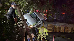 Austin, TX, firefighters rescued a woman who was trapped in her pickup truck between two retaining walls following a one-vehicle crash early Tuesday.