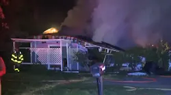 Crews from multiple fire departments battled a blaze that erupted after a house explosion in Commerce Township early Thursday.