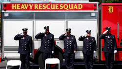 Detroit firefighters salute as 'Taps' is played during a memorial service for firefighter Sgt. Sivad Johnson outside the Detroit Public Safety Headquarters on Monday. Johnson died while trying to rescue two girls who were drowning Aug. 21 in the Detroit River at the Belle Isle Beach.