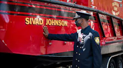 Detroit firefighter Jamal Johnson touches the new fire and rescue boat named after his older brother and fellow firefighter Sgt. Sivad Johnson during a memorial service outside the Detroit Public Safety Headquarters on Monday. Johnson died while trying to rescue two girls who were drowning Aug. 21 in the Detroit River at the Belle Isle Beach.