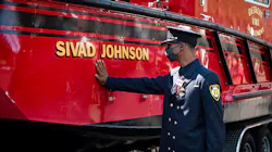 Detroit firefighter Jamal Johnson touches the new fire and rescue boat named after his older brother and fellow firefighter Sgt. Sivad Johnson during a memorial service outside the Detroit Public Safety Headquarters on Monday. Johnson died while trying to rescue two girls who were drowning Aug. 21 in the Detroit River at the Belle Isle Beach.