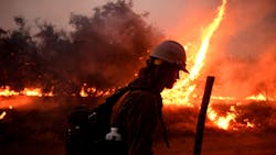 A firefighter helps to set back fires as the El Dorado Fire approaches Tucaipa, CA, on Monday. A firefighter helps to set back fires as the El Dorado Fire approaches Tucaipa, CA, on Monday.