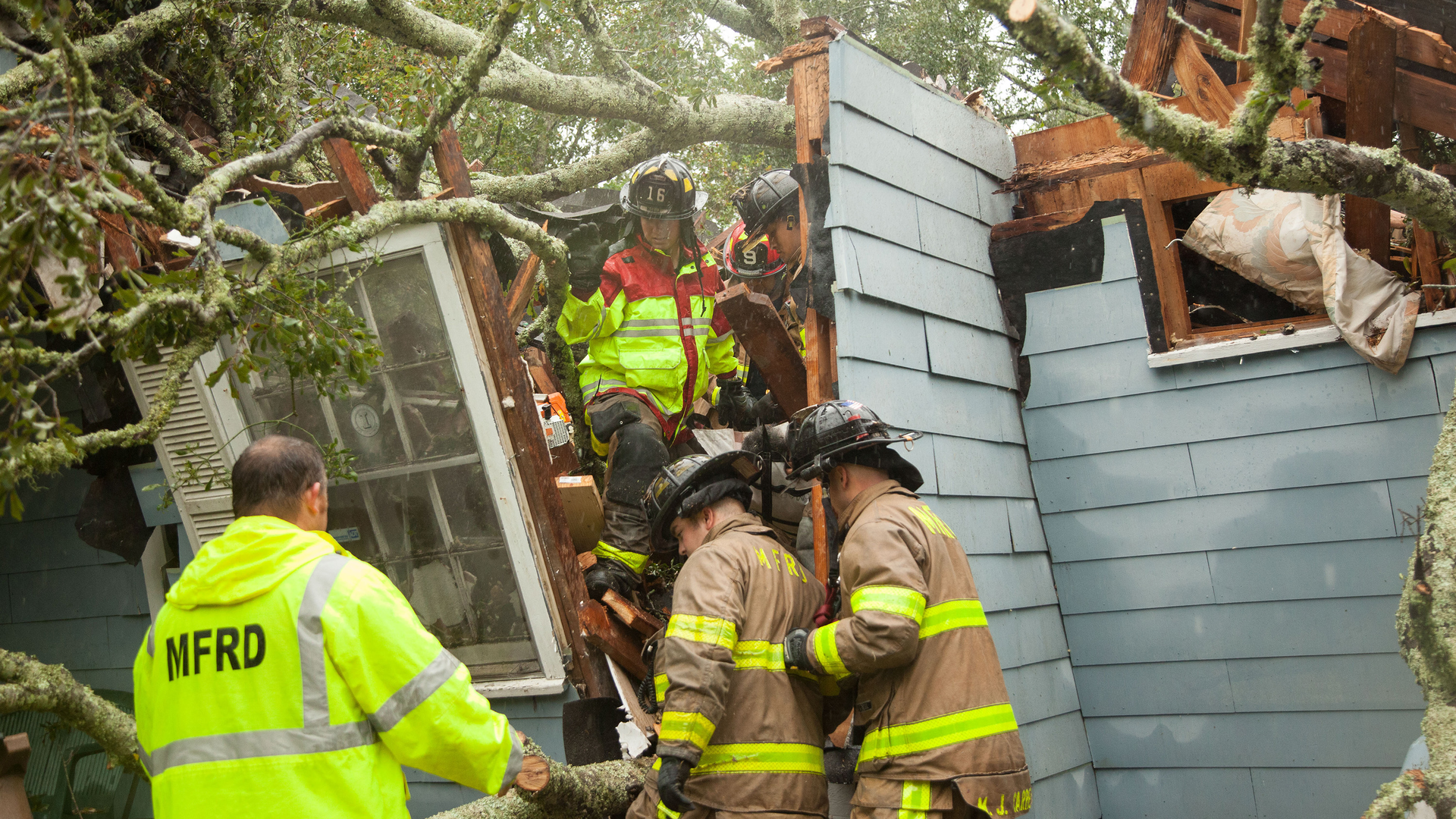 Rescue crews help save Ernestine Law when a tree fell on her house Wednesday in Mobile, AL. Law and her daughter and grandbaby were inside at the time when Hurricane Sally made landfall earlier.