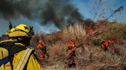 Inmate firefighters clear brush as they work to slow down the spread of the Maria Fire on the Santa Clara river bed, in Santa Paula, CA, on Nov. 1, 2019.