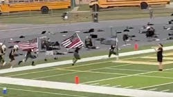 Two Little Miami, OH, High School football players were suspended from the team after carrying &apos;thin red line&apos; and &apos;thin blue line&apos; flags onto the field before a game Friday.