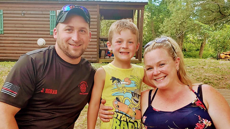 Massena, NY, volunteer firefighter Jason Horan, his partner, Amanda Kenny, and their son, Parker.